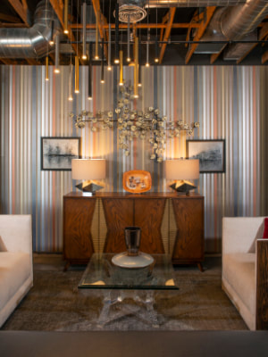 Interior Image with stripped wallpaper, a credenza and lighting